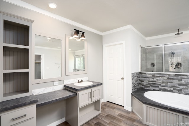 bathroom featuring crown molding, vanity, wood-type flooring, and independent shower and bath