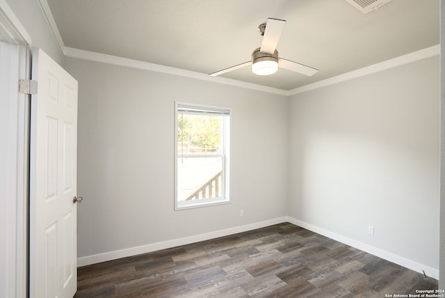 empty room with ceiling fan, dark hardwood / wood-style floors, and ornamental molding