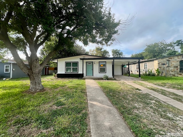 single story home with a carport and a front yard