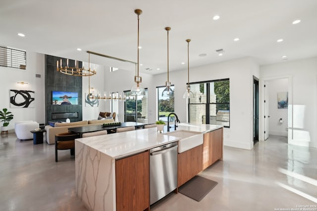 kitchen featuring light stone countertops, a spacious island, stainless steel dishwasher, hanging light fixtures, and sink