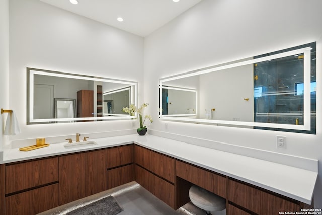 bathroom with vanity and a shower with door