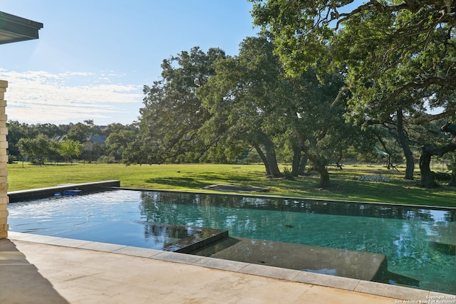 view of pool featuring a yard