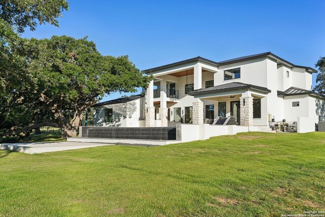 rear view of house featuring a lawn