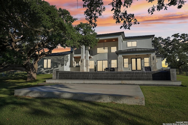 back house at dusk with a yard