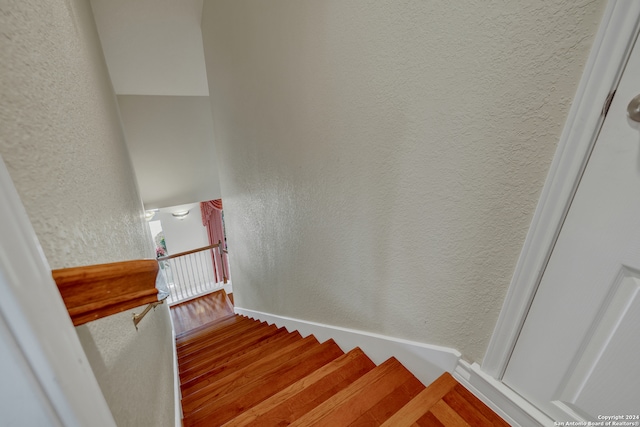 stairway featuring hardwood / wood-style flooring