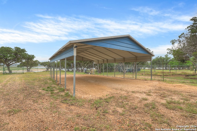 view of yard featuring a carport and a rural view