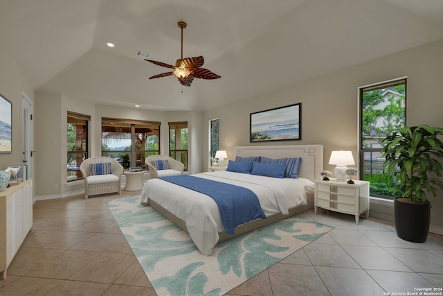 bedroom with multiple windows, vaulted ceiling, light tile patterned floors, and ceiling fan