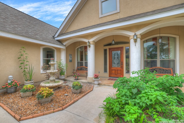 view of exterior entry with covered porch