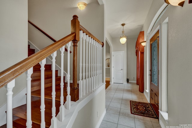 foyer entrance with light tile patterned flooring