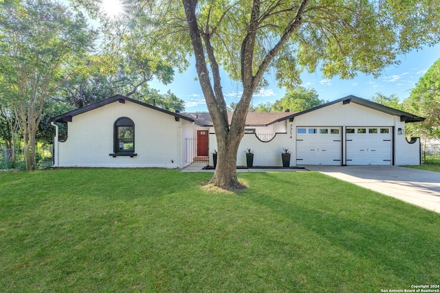 ranch-style home featuring a front yard and a garage