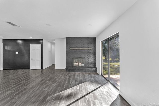 unfurnished living room featuring a fireplace and dark hardwood / wood-style flooring