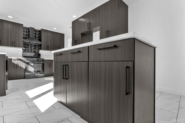 kitchen with black range with gas stovetop and wall chimney range hood