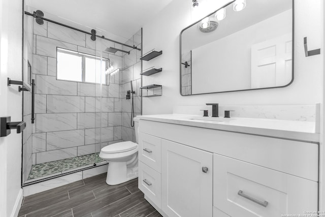 bathroom featuring vanity, toilet, and an enclosed shower