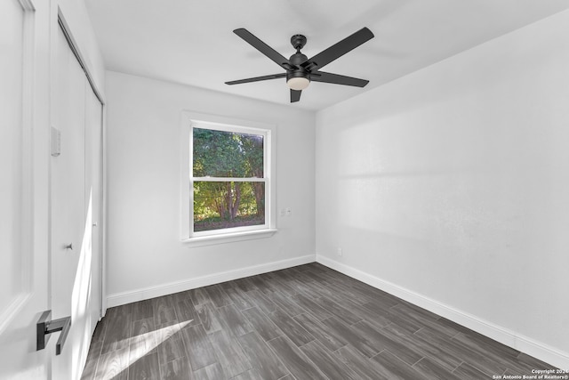 unfurnished room with dark hardwood / wood-style floors and ceiling fan