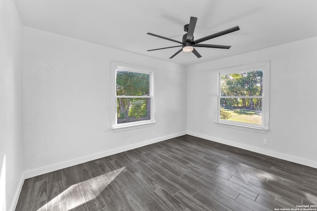 spare room with ceiling fan and dark hardwood / wood-style floors