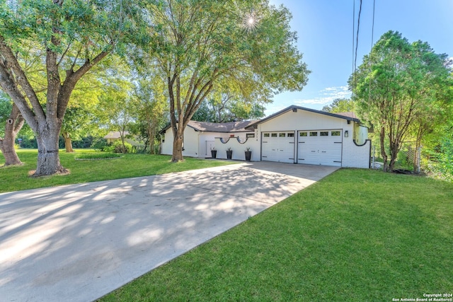 view of front of property featuring a garage and a front lawn