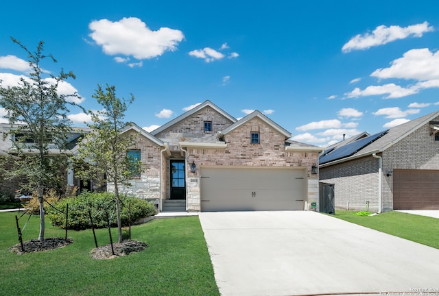 view of front facade with a garage and a front lawn