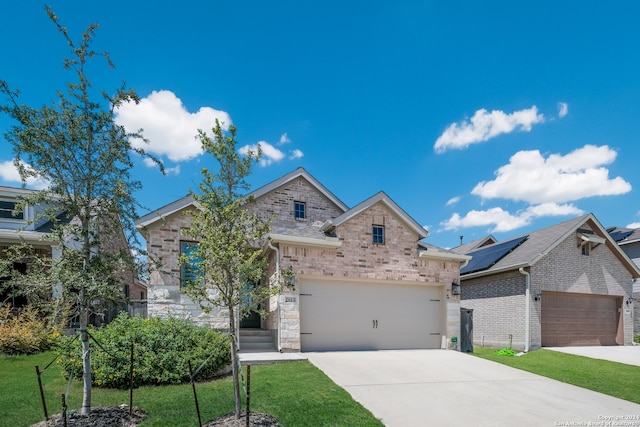 view of front of home with a garage and a front yard