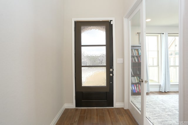 doorway to outside with plenty of natural light and dark hardwood / wood-style floors