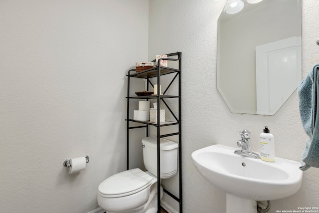 bathroom featuring sink and toilet