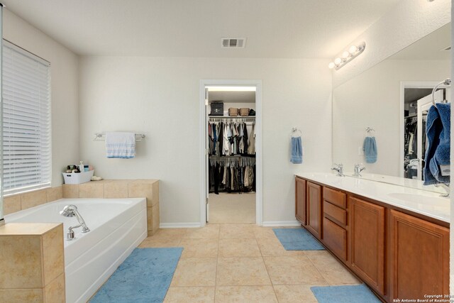 bathroom featuring vanity, a bathtub, and tile patterned floors