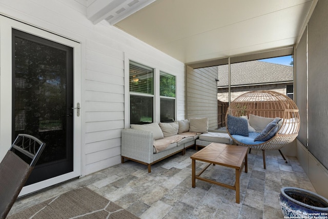 sunroom featuring beam ceiling