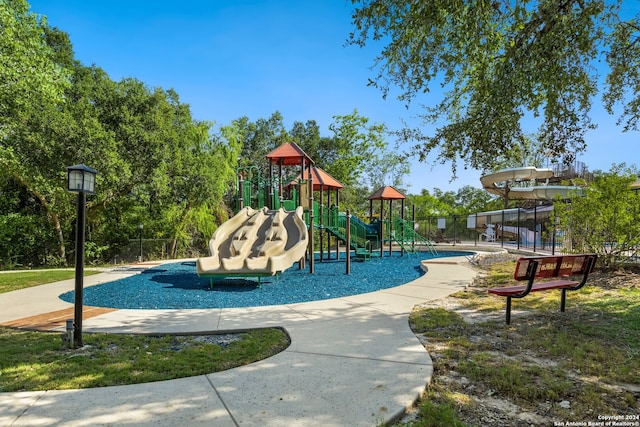 view of playground featuring a swimming pool