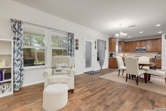 dining area with a notable chandelier and dark wood-type flooring