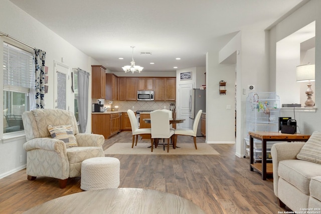 living room featuring hardwood / wood-style floors and a notable chandelier