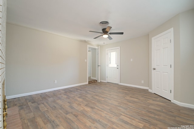 spare room featuring ceiling fan and dark hardwood / wood-style floors