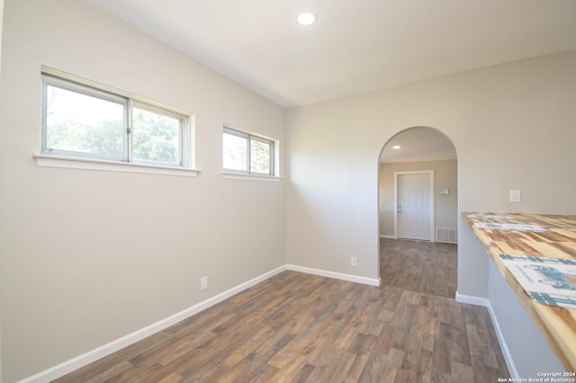 spare room with dark wood-type flooring