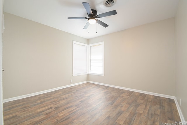 empty room featuring dark hardwood / wood-style flooring and ceiling fan