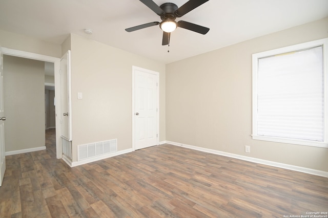 unfurnished bedroom featuring ceiling fan and dark hardwood / wood-style floors