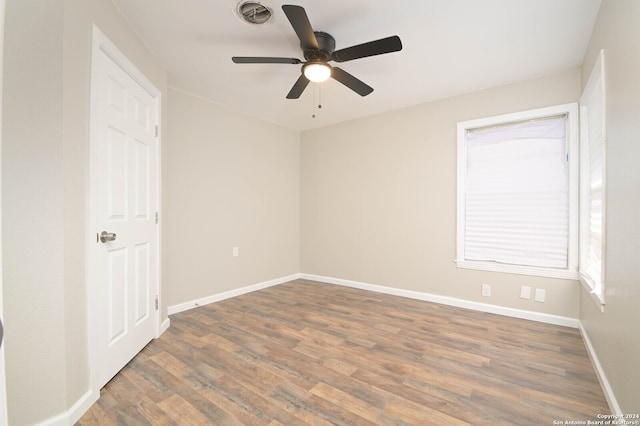 spare room featuring dark hardwood / wood-style flooring and ceiling fan