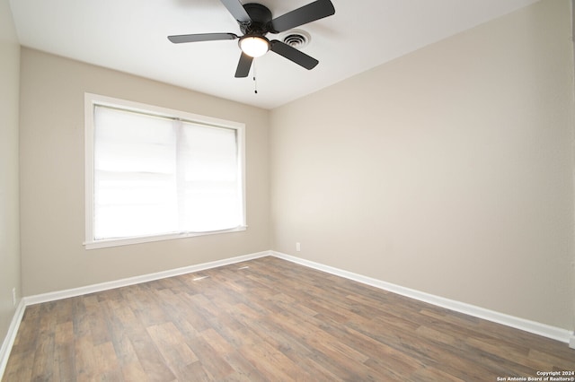 spare room featuring ceiling fan and dark hardwood / wood-style floors