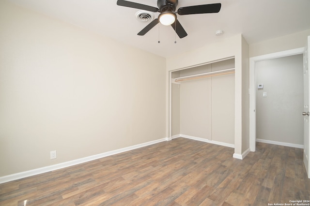 unfurnished bedroom featuring a closet, ceiling fan, and dark hardwood / wood-style flooring