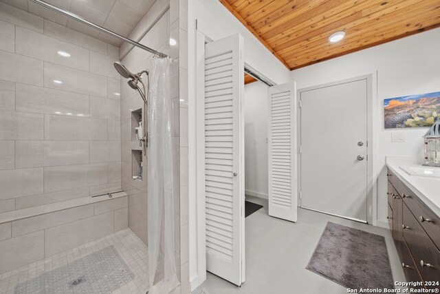 bathroom with wooden ceiling, vanity, concrete floors, and a shower with curtain