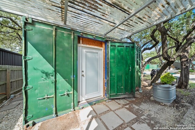 property entrance with a pergola