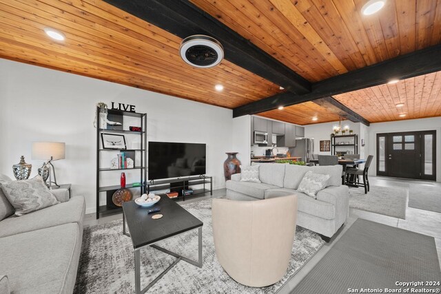 tiled living room with wood ceiling, beam ceiling, and a notable chandelier