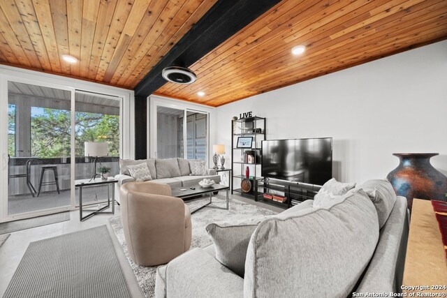 living room featuring concrete flooring and wood ceiling