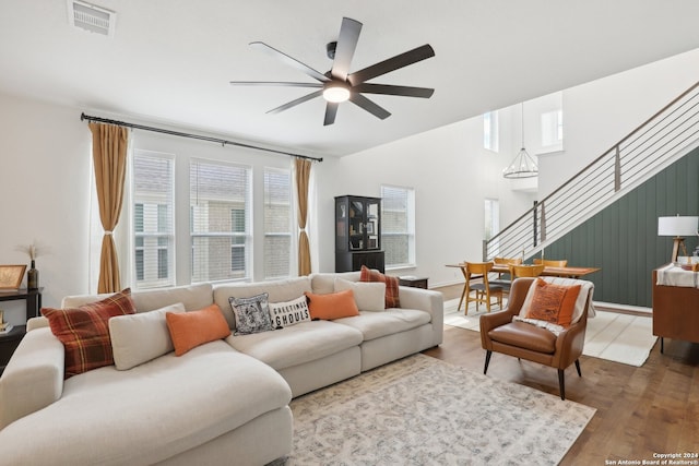 living room featuring ceiling fan and hardwood / wood-style floors