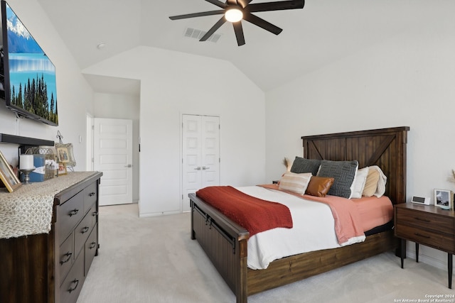 carpeted bedroom with a closet, ceiling fan, and vaulted ceiling