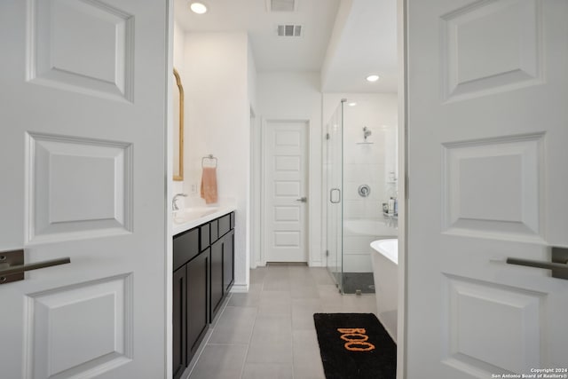 bathroom featuring vanity, separate shower and tub, and tile patterned floors