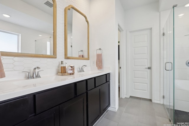 bathroom with tile patterned flooring, vanity, backsplash, and walk in shower