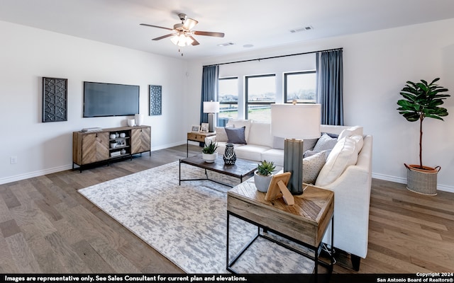 living room with hardwood / wood-style floors and ceiling fan