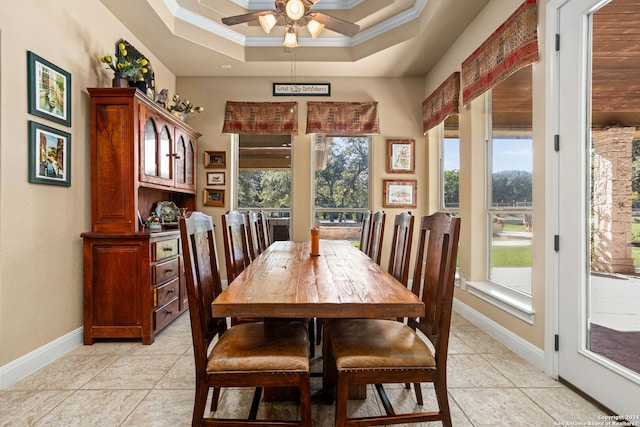 dining room featuring crown molding, ceiling fan, light tile patterned floors, and a raised ceiling