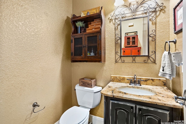 bathroom with toilet and vanity