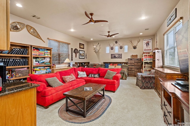 living room with ceiling fan and light colored carpet