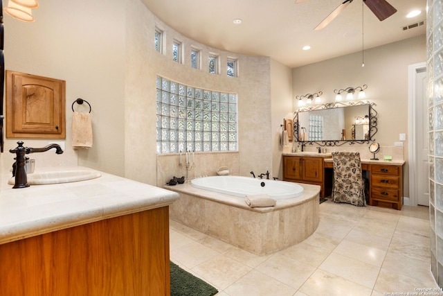 bathroom with vanity, tiled bath, tile patterned floors, and ceiling fan