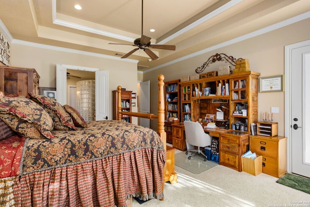 carpeted bedroom with crown molding, a tray ceiling, and ceiling fan